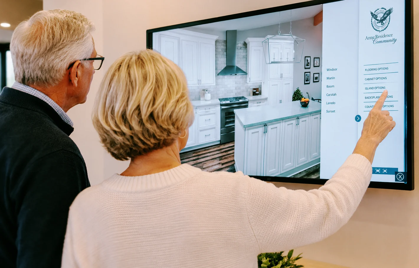Couple choosing kitchen finishes on a CustomSpace touchscreen at Army Residence Community
